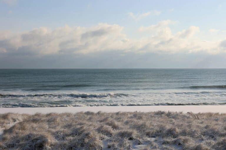 Serene winter beach with waves and sand dunes in Mantoloking, NJ.