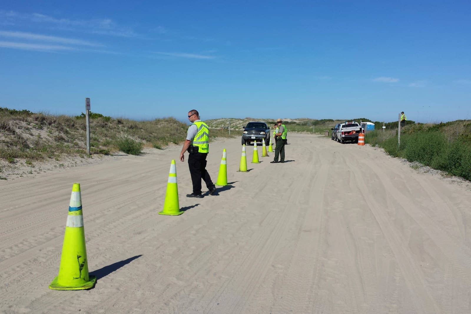 National Park Service rangers running a vehicle safety and permit check on a sand access road at Cape Hatteras National Seashore