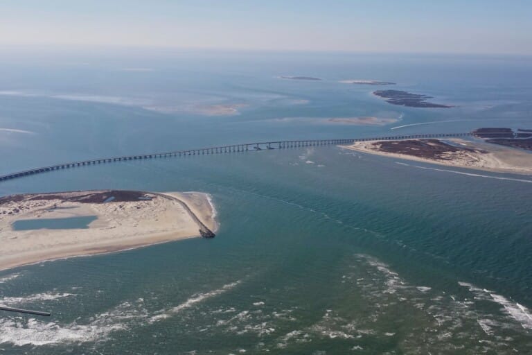 Aerial view of Oregon Inlet on the Outer Banks, with the bridge crossing to Pea Island and shoals in the channel