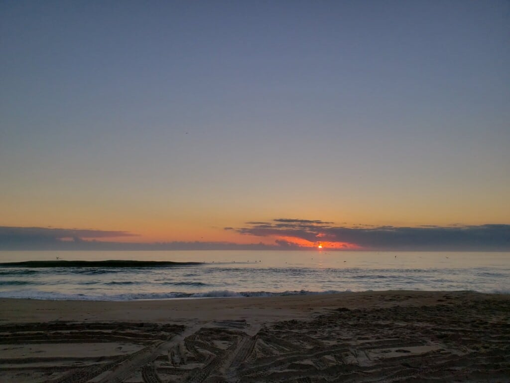Orange sunrise over the ocean at Cape Point on Hatteras Island