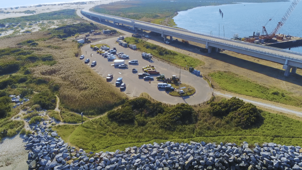 Aerial view of the Bonner Bridge Pier parking area with the Marc Basnight Bridge behind it