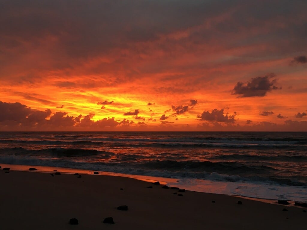 Fiery orange sunrise over the surf at Cape Point in October