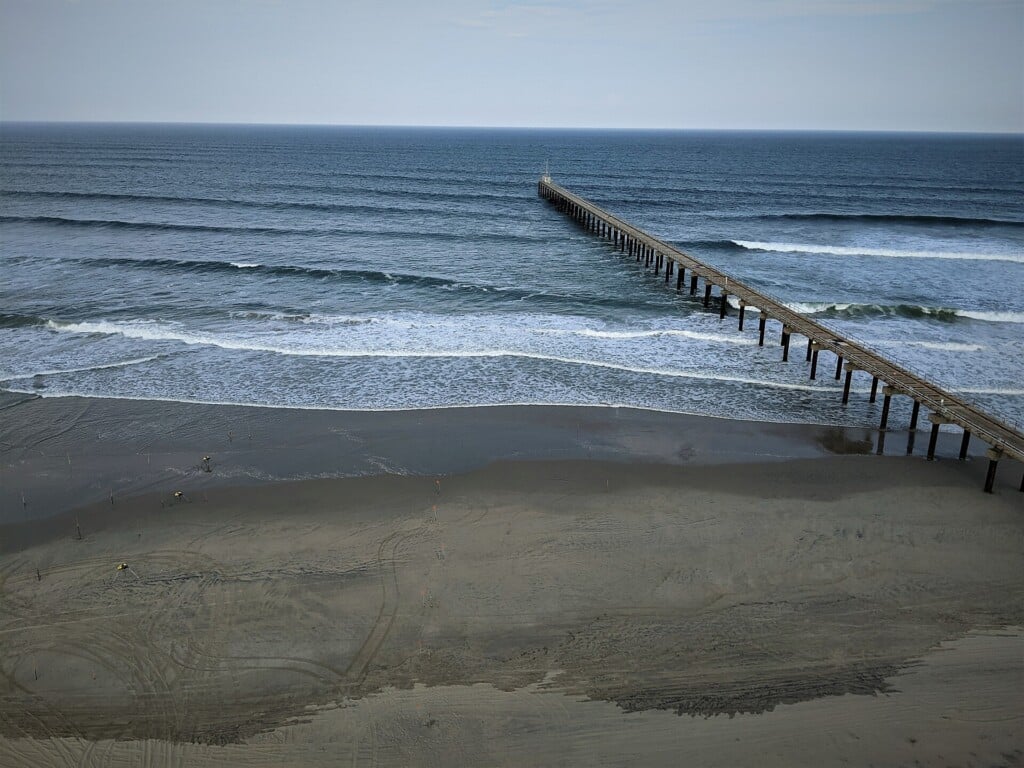 The research pier at Duck with instrument poles in the surf zone