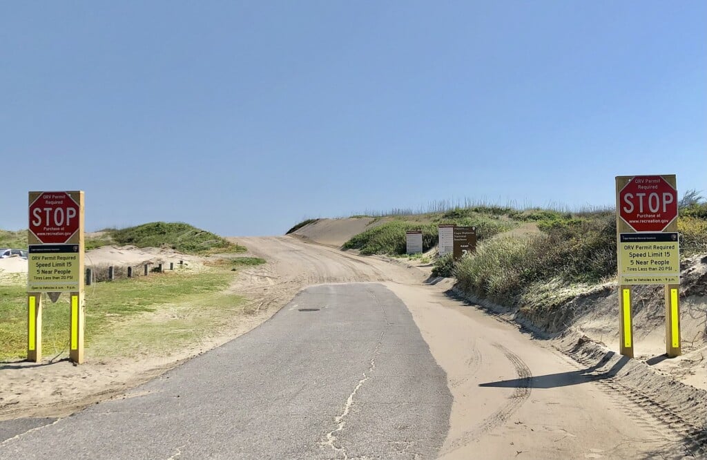 Stop signs and ORV rule signs at the entrance to Ramp 2 on Bodie Island